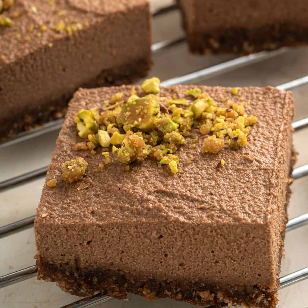 No Bake Vegan Chocolate Cheesecake Bars, a delicious dessert recipe featuring a lush chocolate cheesecake on top of a moist and sweet crust.