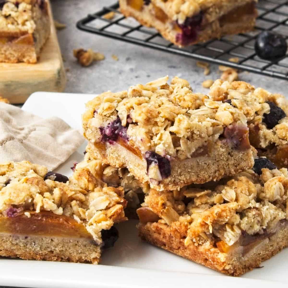 Vegan Fruit Crumble Bars are a simple layered dessert or snack recipe made with healthy ingredients including blueberries and oats.