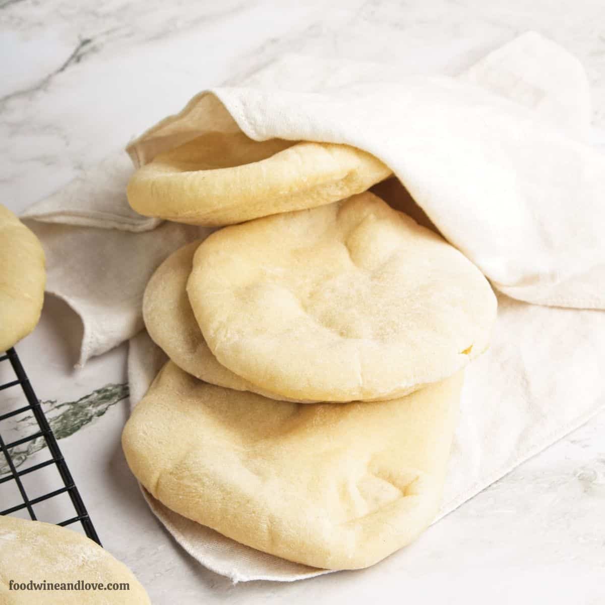 Homemade Mini Pita Bread Recipe, a simple and tasty five ingredients bread that is soft and fluffy. Perfect size for sandwiches or snacking.